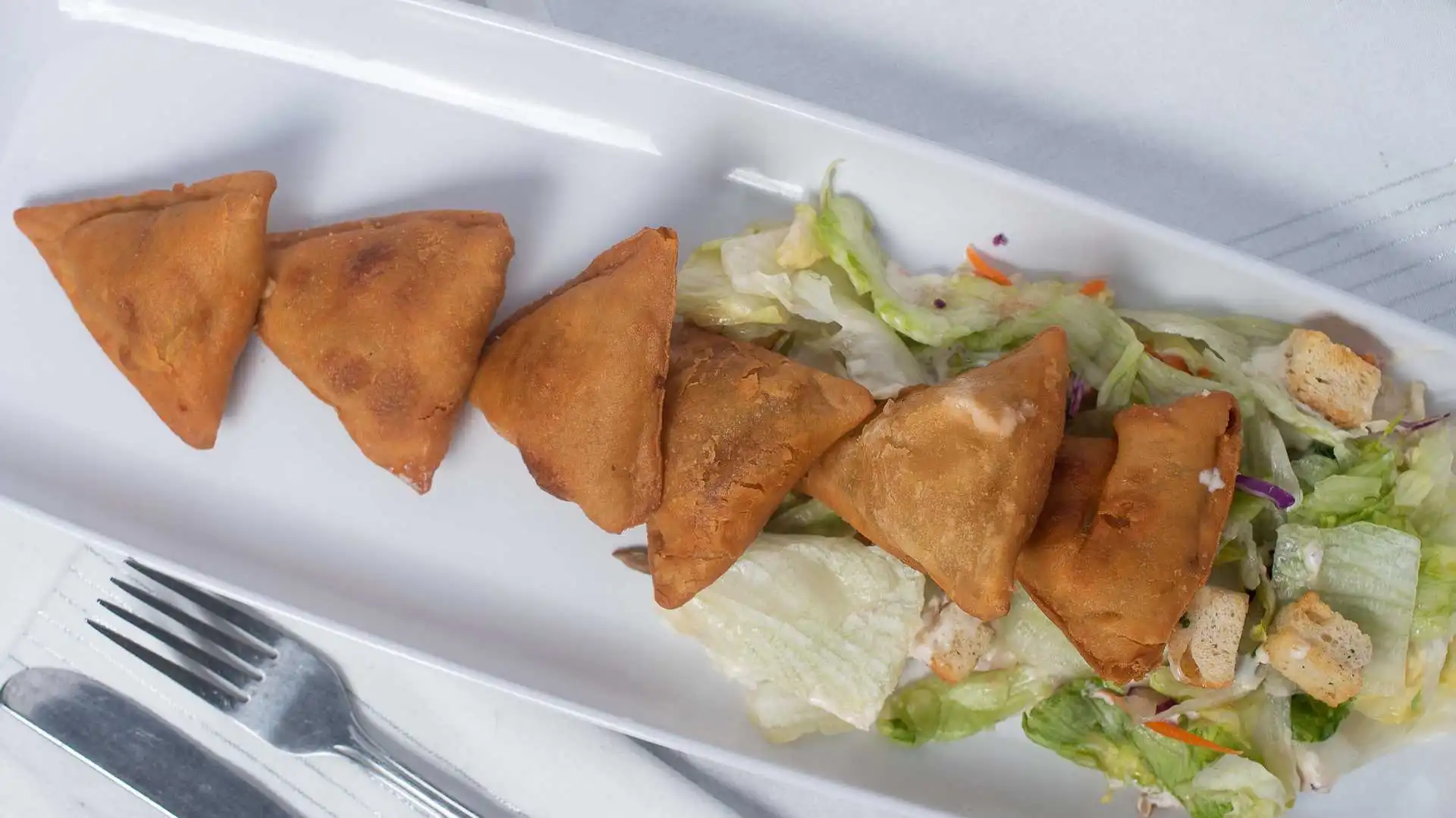 Samosas at Afghan Chopan Kebab Edmonton - crispy fried pastries with savory fillings